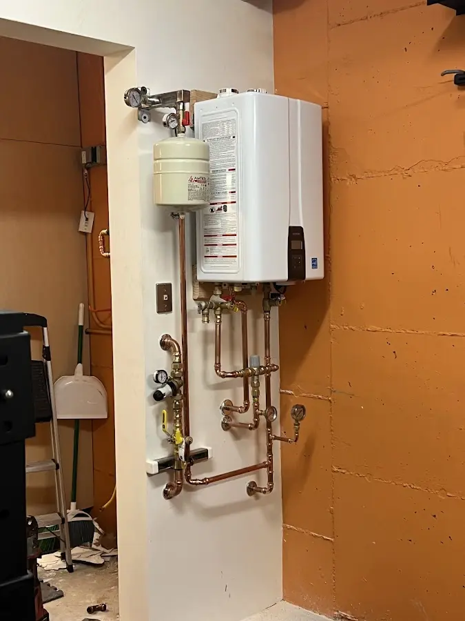 Plumbing technician inspecting water heater connections in Redondo Beach